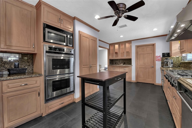 kitchen featuring stainless steel appliances, extractor fan, decorative backsplash, and dark tile patterned floors