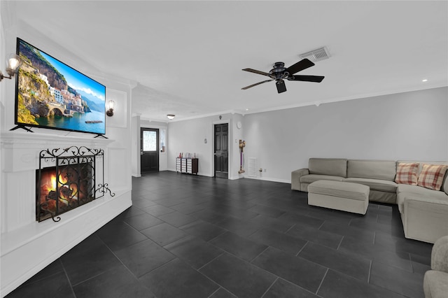 unfurnished living room with ornamental molding, dark tile patterned floors, and ceiling fan