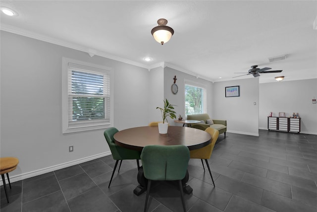 tiled dining room with crown molding and ceiling fan