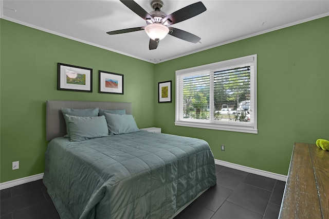 bedroom with ornamental molding, ceiling fan, and dark tile patterned flooring