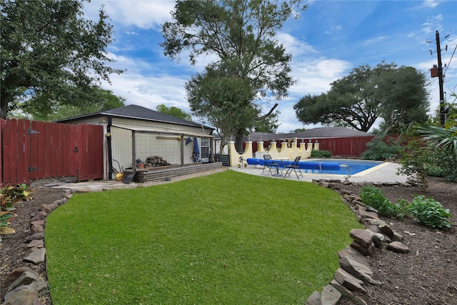 view of yard with a fenced in pool and a patio