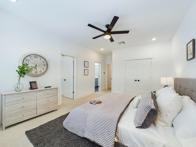 bedroom featuring light carpet and ceiling fan