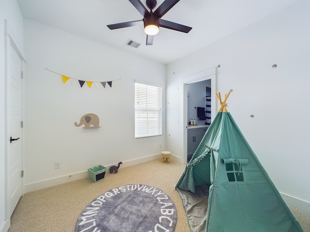 interior space with ceiling fan and carpet