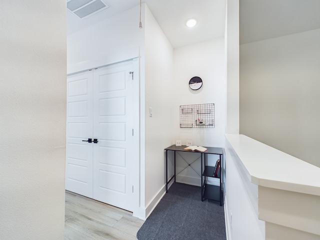 corridor with light hardwood / wood-style flooring