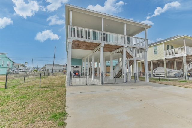 rear view of property with a lawn and a carport