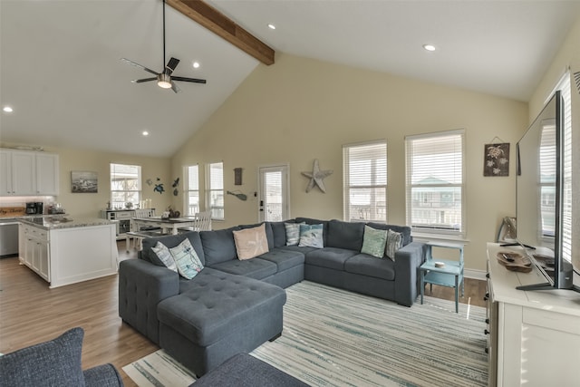 living room with high vaulted ceiling, ceiling fan, beamed ceiling, and light hardwood / wood-style flooring