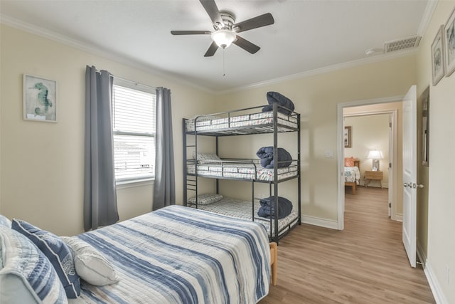 bedroom with ornamental molding, ceiling fan, and hardwood / wood-style floors