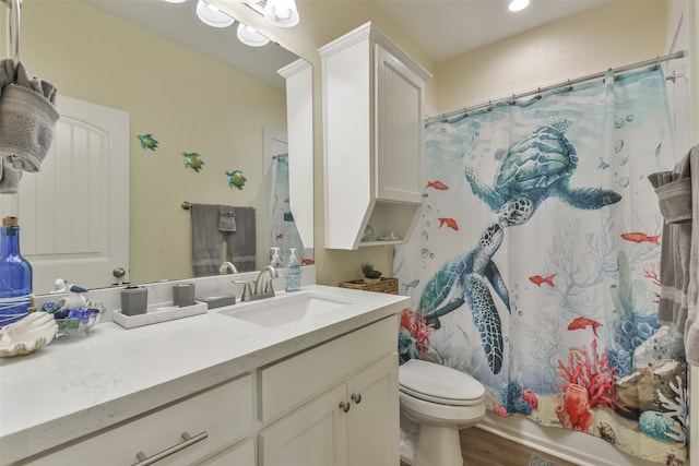 full bathroom with wood-type flooring, shower / bath combo, vanity, and toilet