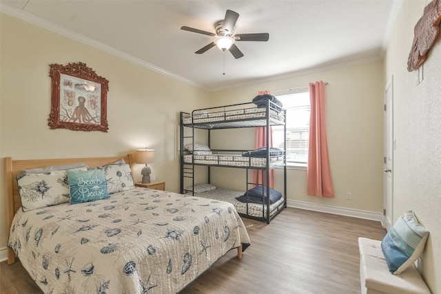 bedroom featuring crown molding, hardwood / wood-style floors, and ceiling fan