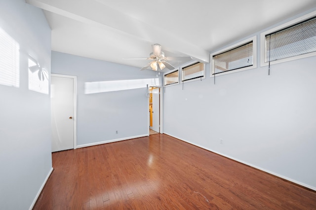 unfurnished room with beamed ceiling, wood-type flooring, and ceiling fan