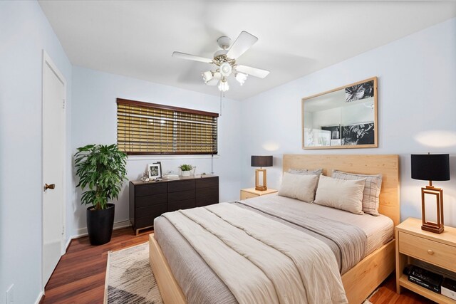 bedroom featuring ceiling fan and dark wood-type flooring