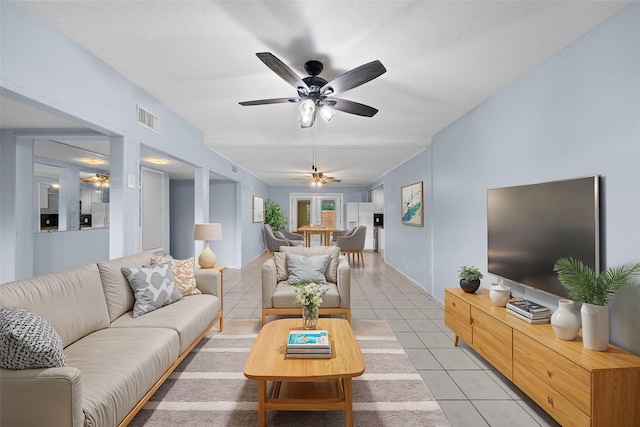 living room with ceiling fan and light tile patterned flooring