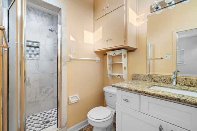 bathroom featuring vanity, toilet, and a shower with shower door