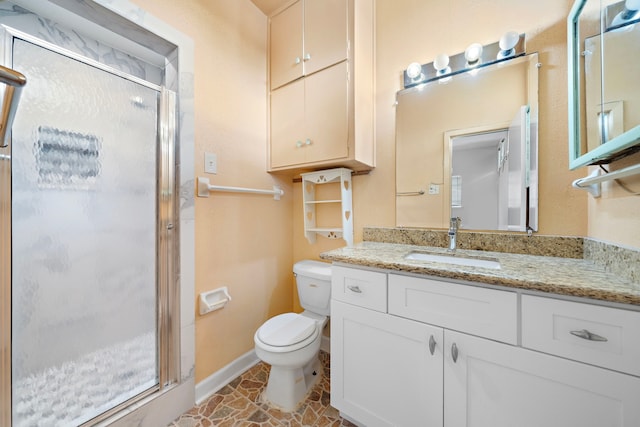 bathroom featuring vanity, toilet, and an enclosed shower