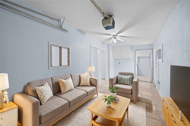 living room featuring light tile patterned flooring and a textured ceiling