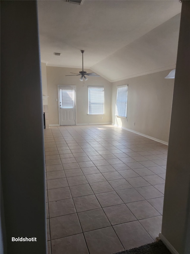 unfurnished room featuring lofted ceiling, ceiling fan, and light tile patterned floors