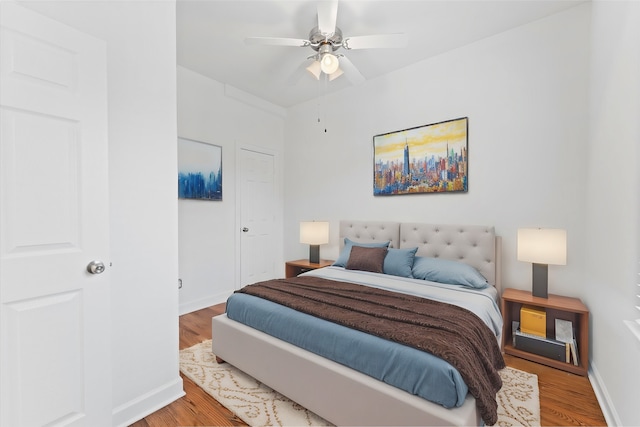 bedroom with ceiling fan and wood-type flooring