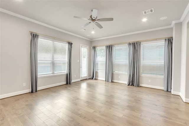 spare room featuring ornamental molding, light wood-type flooring, and ceiling fan