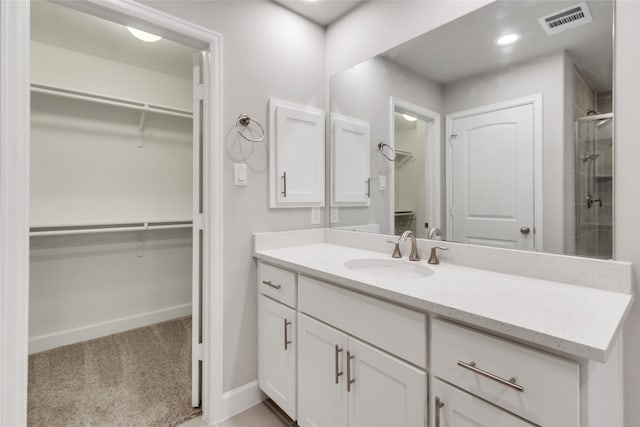 bathroom with vanity and an enclosed shower