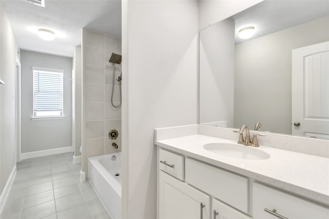 bathroom featuring vanity, tiled shower / bath combo, and tile patterned flooring