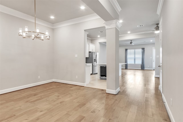 unfurnished dining area featuring wine cooler, light hardwood / wood-style flooring, ceiling fan with notable chandelier, ornate columns, and crown molding