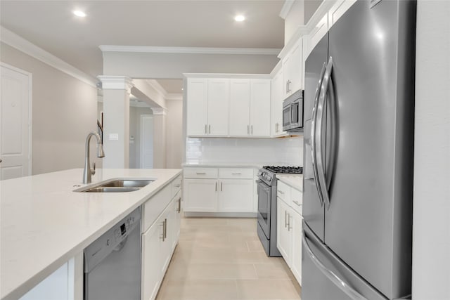 kitchen featuring sink, appliances with stainless steel finishes, white cabinetry, and tasteful backsplash