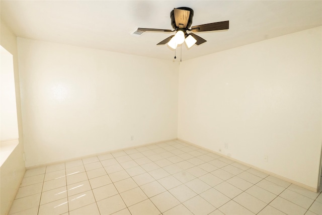 tiled spare room featuring ceiling fan