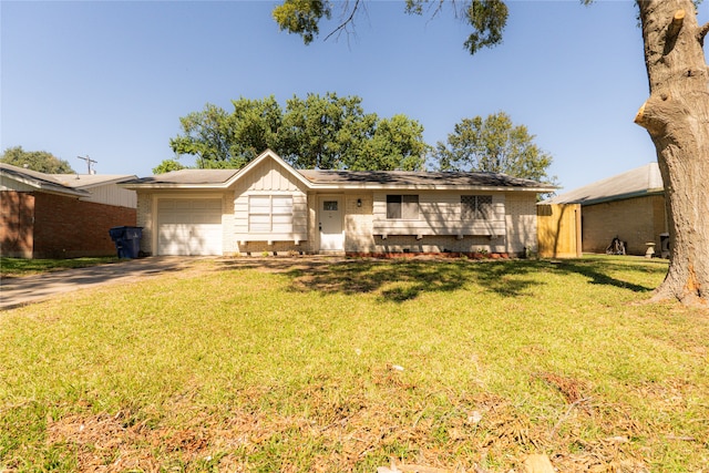 ranch-style house featuring a garage and a front lawn