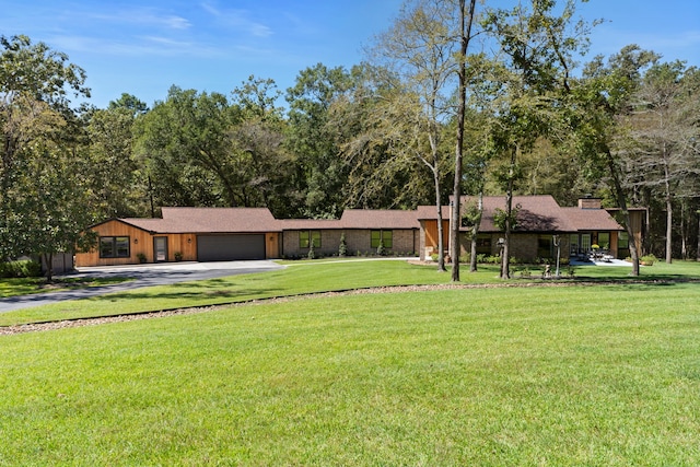 ranch-style home featuring a front yard and a garage