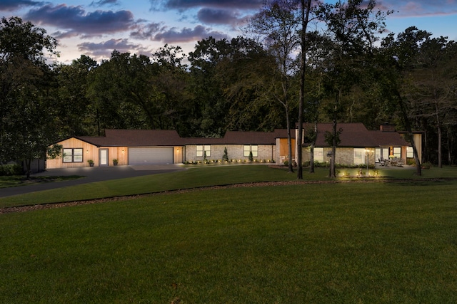 view of front of property with a yard and a garage