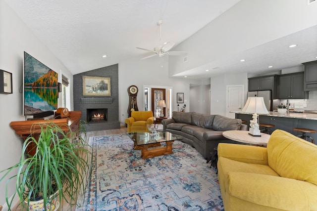 living room featuring a brick fireplace, high vaulted ceiling, ceiling fan, and wood-type flooring