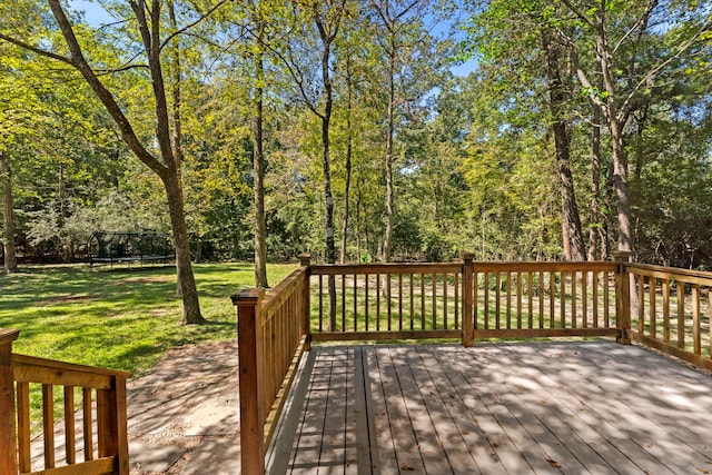 deck with a yard and a trampoline