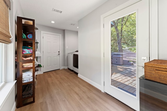 washroom featuring washer / clothes dryer and light wood-type flooring