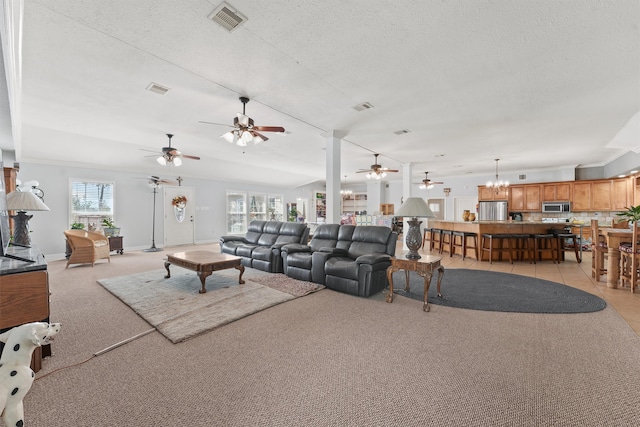 carpeted living room featuring a chandelier and a textured ceiling