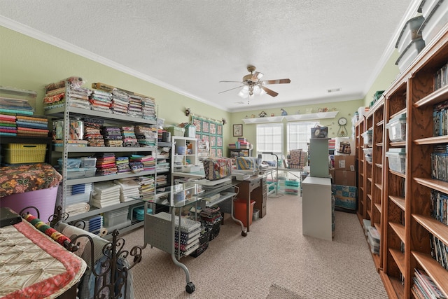 interior space featuring carpet floors, a textured ceiling, ornamental molding, and ceiling fan