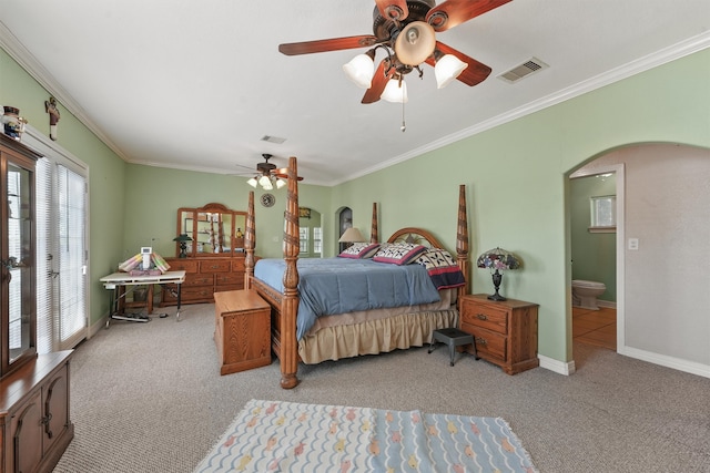 carpeted bedroom with ornamental molding, ceiling fan, and connected bathroom