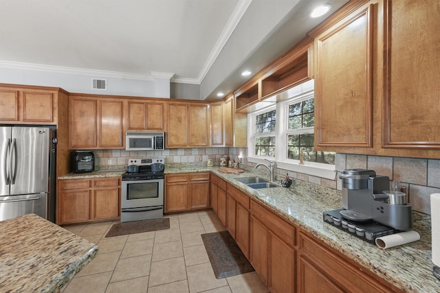 kitchen featuring light tile patterned flooring, sink, stainless steel appliances, crown molding, and decorative backsplash