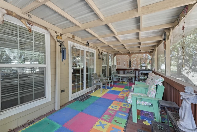 sunroom featuring beam ceiling