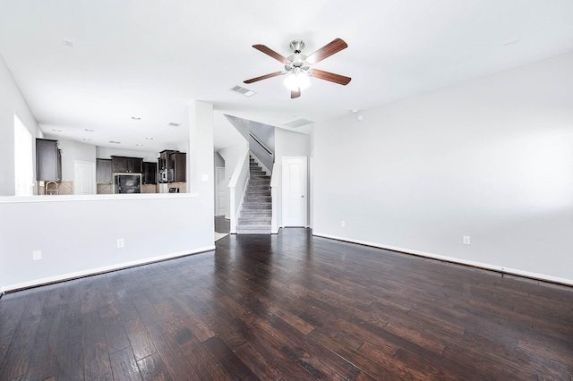 12915 Madison Boulder Ln, Humble, TX 77346 - unfurnished living room featuring a ceiling fan, baseboards, wood finished floors, visible vents, and stairway