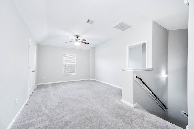 carpeted spare room featuring ceiling fan