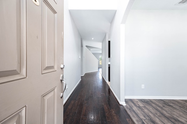 corridor with dark hardwood / wood-style floors