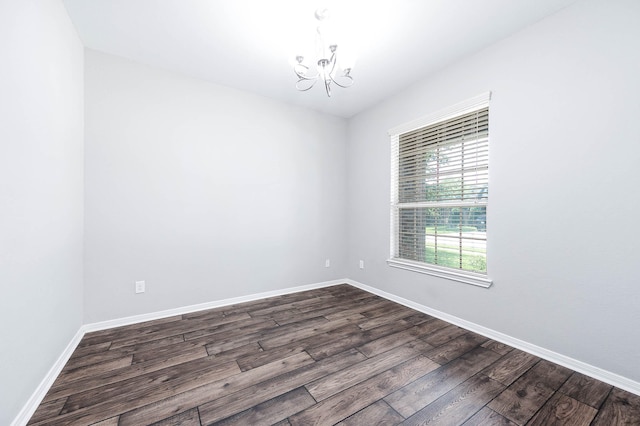 12915 Madison Boulder Ln, Humble, TX 77346 - unfurnished room with an inviting chandelier, baseboards, and dark wood finished floors