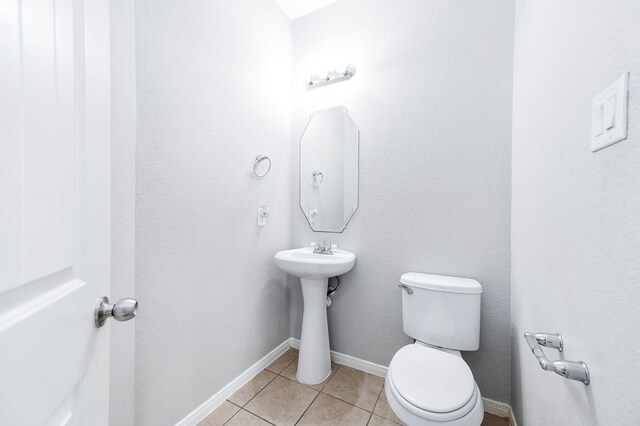 bathroom with sink, tile patterned flooring, and toilet