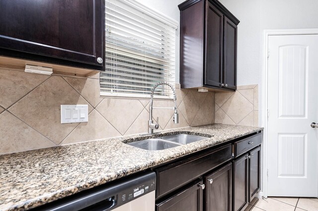 12915 Madison Boulder Ln, Humble, TX 77346 - kitchen with stainless steel dishwasher, light stone countertops, a sink, and tasteful backsplash