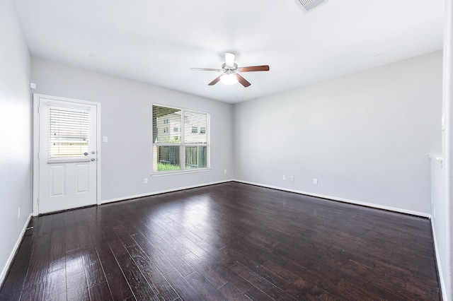 empty room featuring dark wood-type flooring and ceiling fan