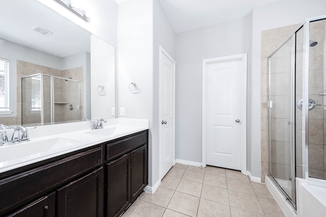 bathroom featuring a shower with door, tile patterned floors, and vanity