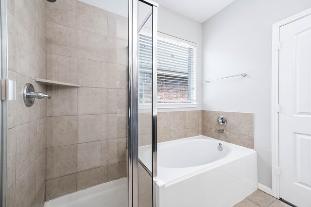12915 Madison Boulder Ln, Humble, TX 77346 - bathroom featuring tile patterned floors, a shower stall, and a bath