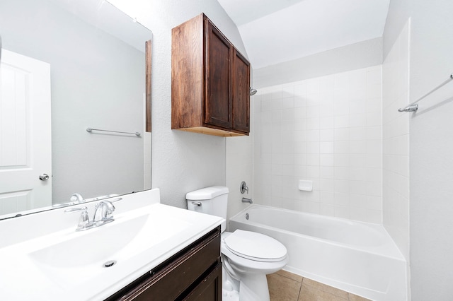 full bathroom with tile patterned flooring, tiled shower / bath, vanity, and toilet