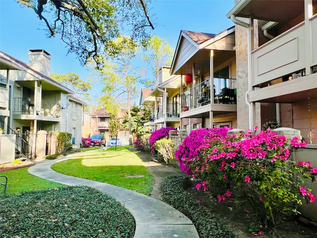 view of yard with a balcony