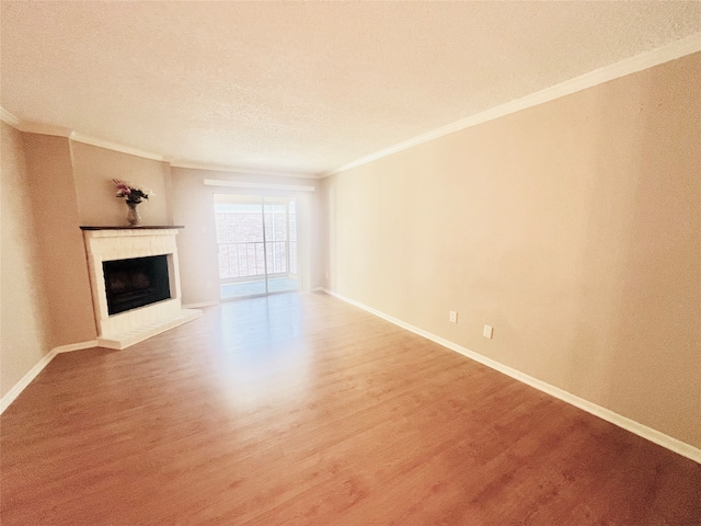 unfurnished living room with ornamental molding, a textured ceiling, and wood-type flooring